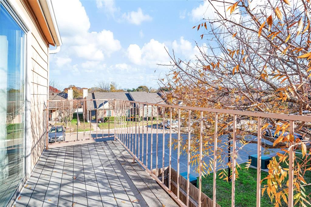 Balcony overlooking the parking lot and grass area