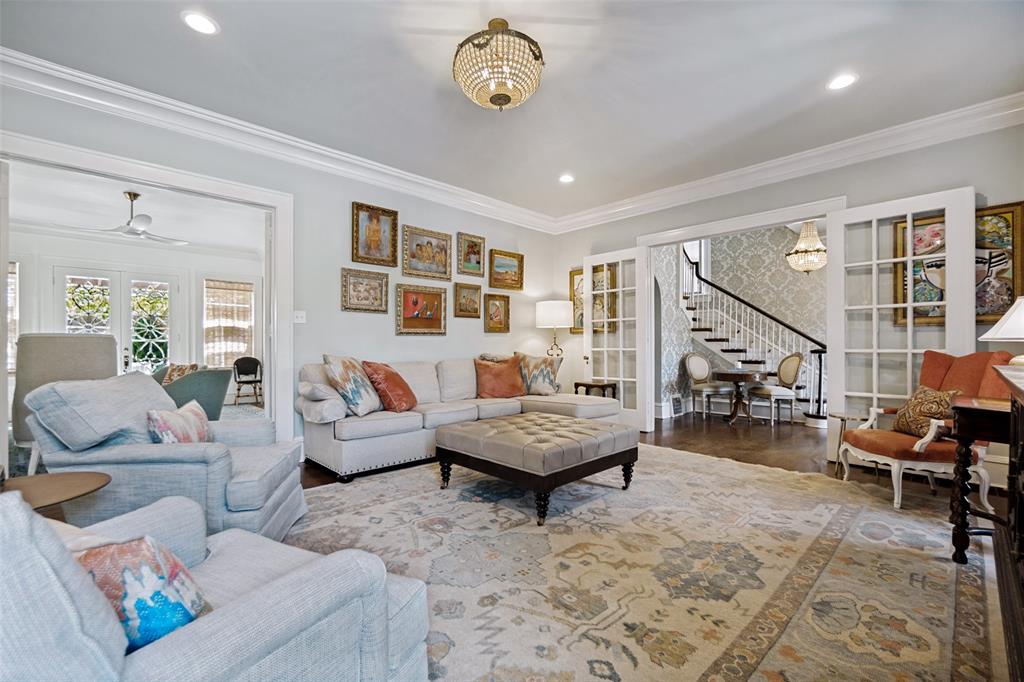 Recessed lighting, crown molding, wood-finish flooring, French doors, and a chandelier
