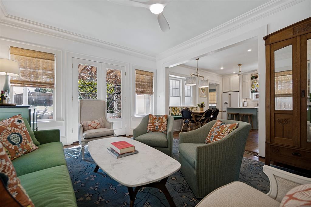 Living space with crown molding, double French doors, wood-finish flooring, and recessed lighting