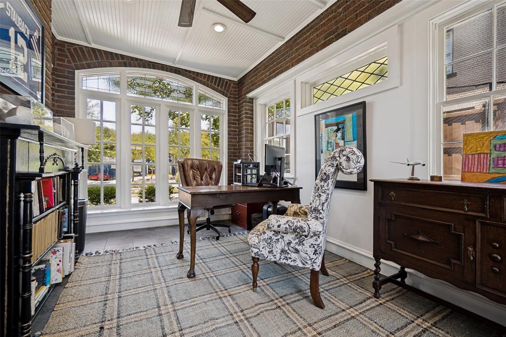 Room featuring brick walls, a white beadboard ceiling, and light-colored flooring