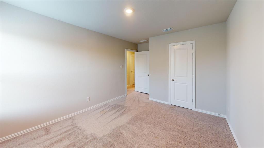 Neutral wall paint, light brown carpeting, white paneled doors, and recessed lighting