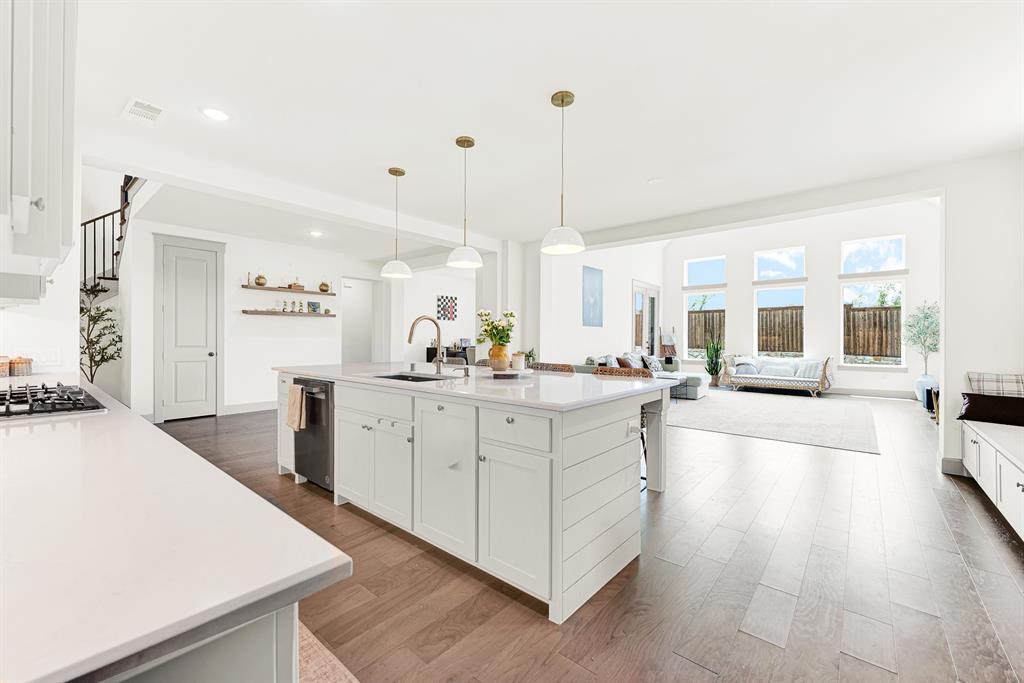 Expansive open-concept layout connects the main cooking hub seamlessly to light-filled adjacent spaces. Perfect for hosting big holiday parties without missing any conversation.