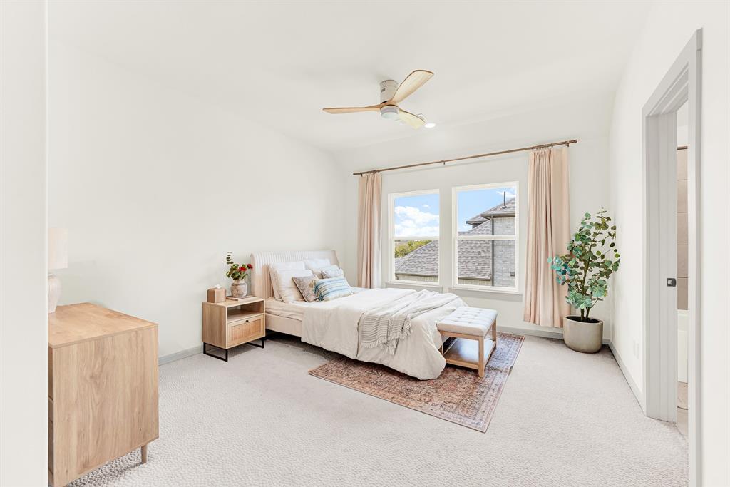 A tall framed doorway opens smoothly into a spacious, light-filled sleeping sanctuary. Teenagers or overnight visitors can enjoy peaceful late-night relaxation with plenty of room to stretch out