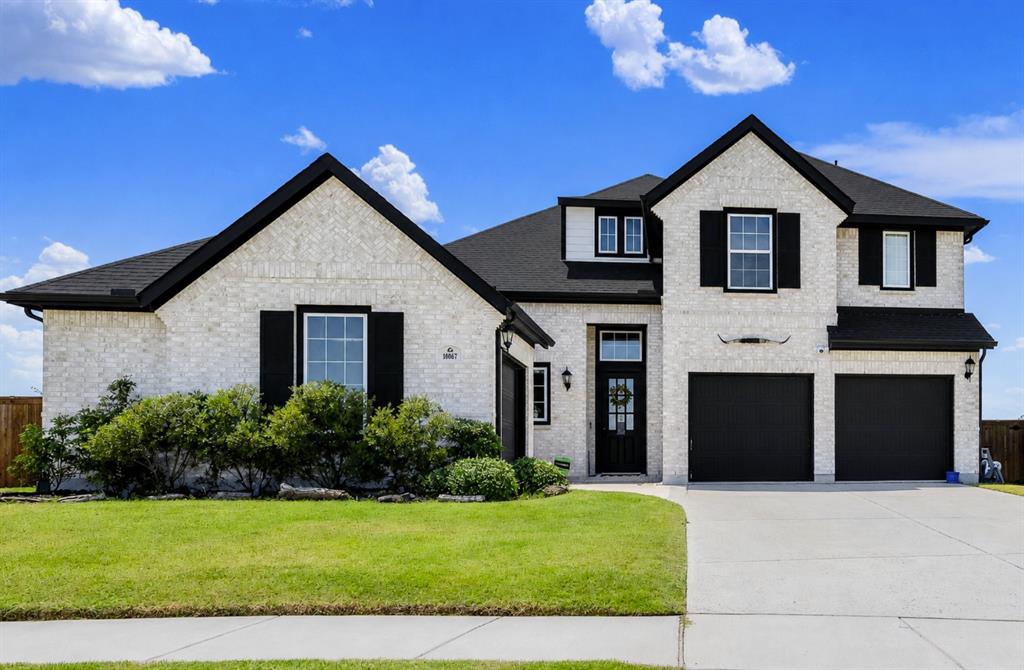 Welcome to 10067 Clover Forest in Frisco.  Light-colored brickwork and dark gables define a striking, balanced façade under bright Texas skies. Coming home feels like a true breath of fresh air as you pull up the wide driveway after a busy day.