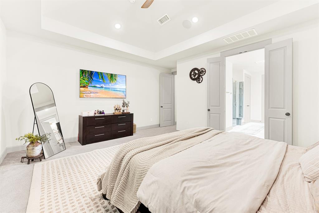 Double entry doors open directly into the connected bath retreat across a vast carpeted footprint. Picture waking up refreshed and strolling straight into your private morning routine.