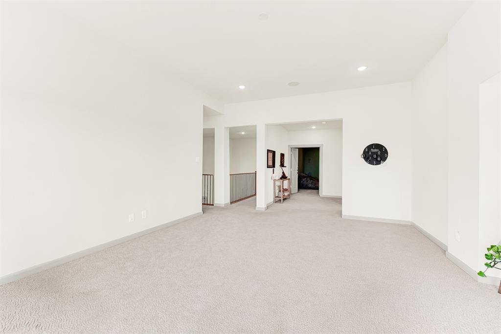 Clean, crisp walls and open passageways create an effortless connection to the rest of the upper level. It is the perfect spot for family game nights that casually spill out into adjacent spaces.