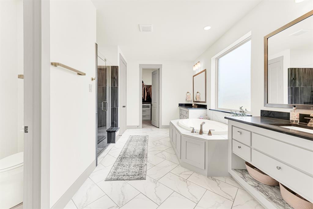 Bright tile flooring laid in a dynamic diagonal pattern draws the eye toward a corner soaking tub. Ideal for washing away workday stress under warm water and quiet privacy.
