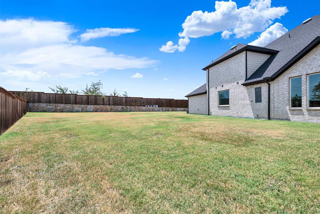 Sweeping rooflines and light brick walls stretch across an impressively wide, flat green expanse. It offers the ideal canvas for hosting lively weekend barbecues with plenty of space for everyone.