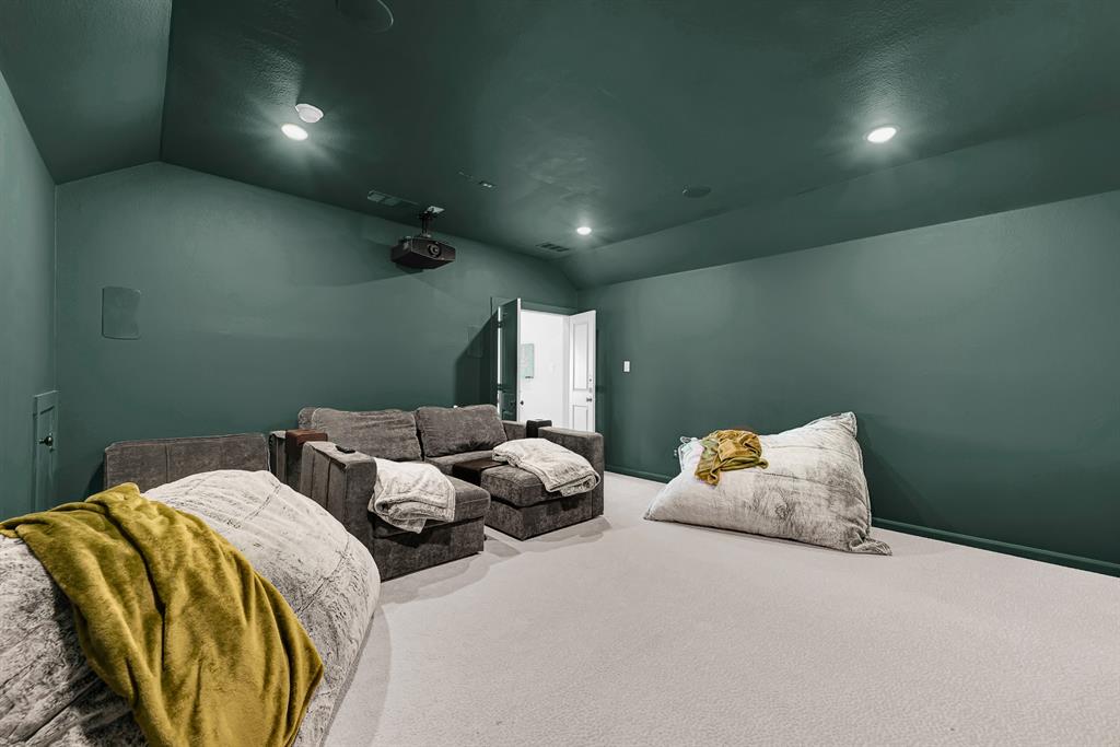 Enclosed dark surfaces and subtle recessed fixtures craft an intimate, cocoon-like atmosphere. It’s tailor-made for hosting game-day watch parties where everyone gets lost in the big-screen action.