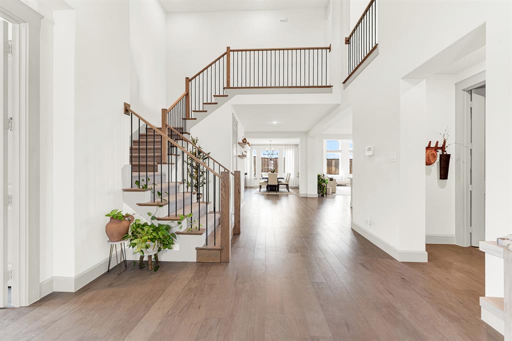 Slender iron balusters and a wrapping upper gallery create an open, airy flow down into the main living spaces below. Imagine stepping down the stairs on a quiet weekend morning, greeted by the comforting smell of fresh coffee brewing nearby Slender iron balusters and a wrapping upper gallery create an open, airy flow down into the main living spaces below. Imagine stepping down the stairs on a quiet weekend morning, greeted by the comforting smell of fresh coffee brewing nearby