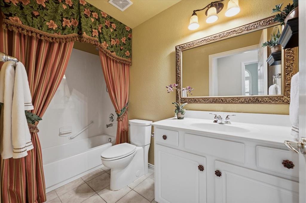 guest bath next to front bedroom - has linen closet also; combo tub shower picture prior to curtain removed and updated paint color N -   DRAPES REMOVED - PAINTED NATURAL LINENN WALL COLOR