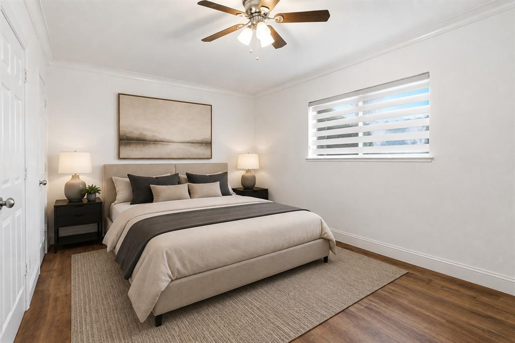 Virtually staged to demonstrate the scale and layout of the primary bedroom. Updated flooring and fresh paint create a clean, neutral backdrop.