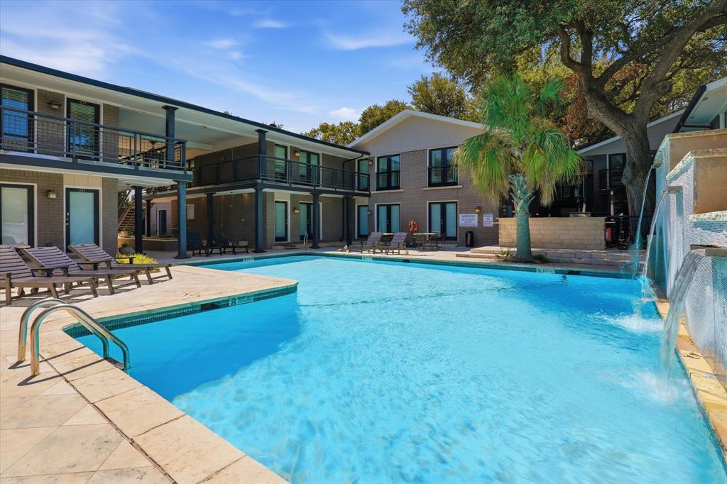 Additional view of the pool area surrounded by mature landscaping and the residential buildings just steps from your condo.