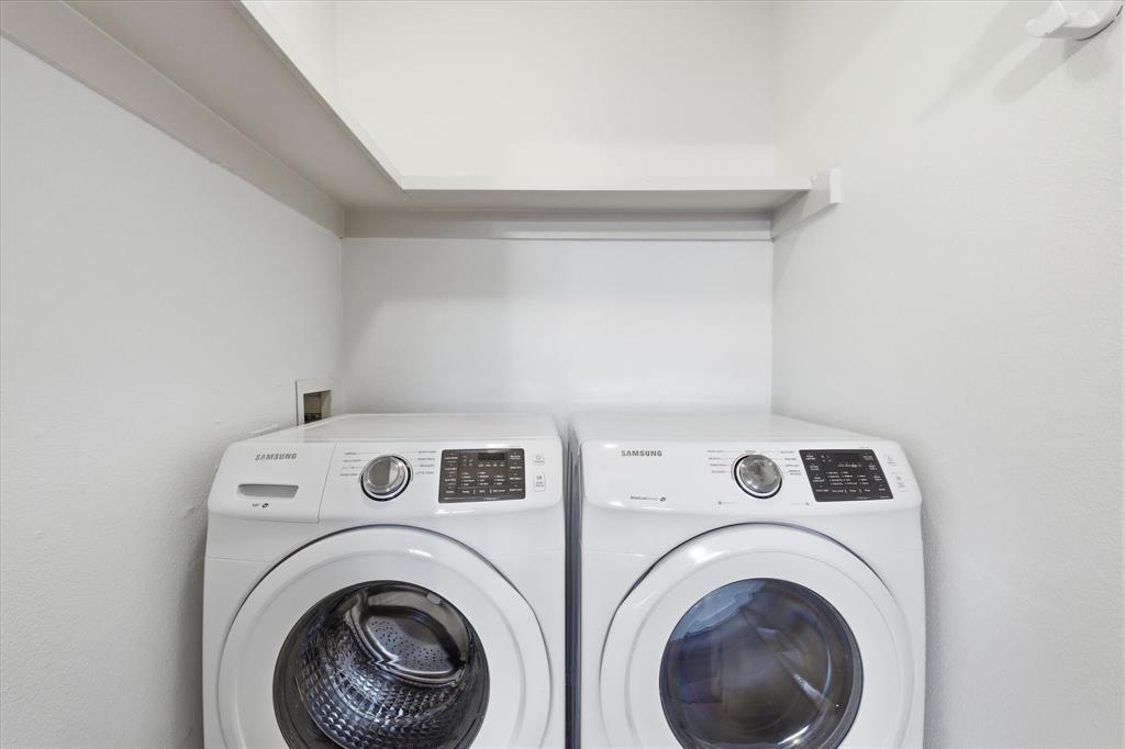 Dedicated in-unit utility space with full-size washer and dryer that convey with the condo sale.  Tucked away discretely in the primary bedroom.
