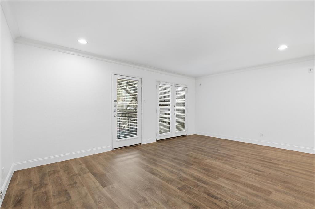 Living area with French doors providing natural light and access to the outdoor patio.