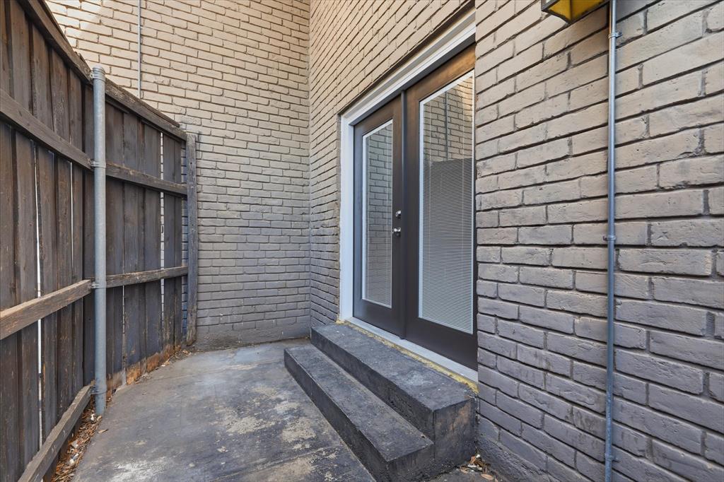 Private outdoor patio located just outside the secondary bedroom offers a low maintenance space for a few chairs or a gorgeous area for your potted plants, twinkle lights and turf.