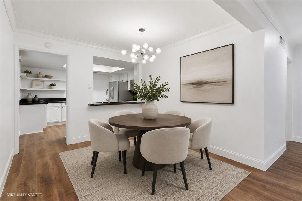 Virtually staged dining area showing its convenient connection to the kitchen and living space. The open layout allows the rooms to flow naturally together.