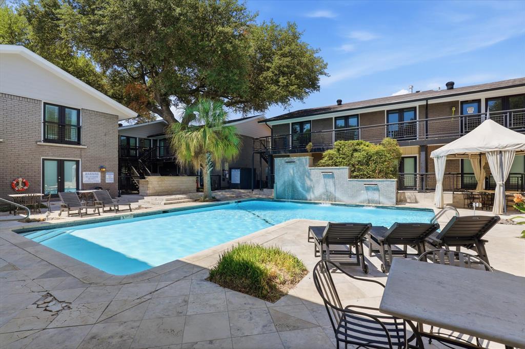 Another view of the nearby community pool with its tranquil waterfalls and surrounding lounge area.
