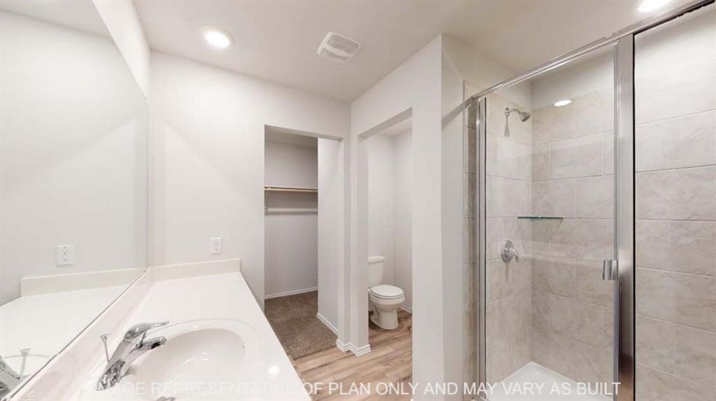 White vanity with integrated sink, chrome faucet, and expansive wall mirror