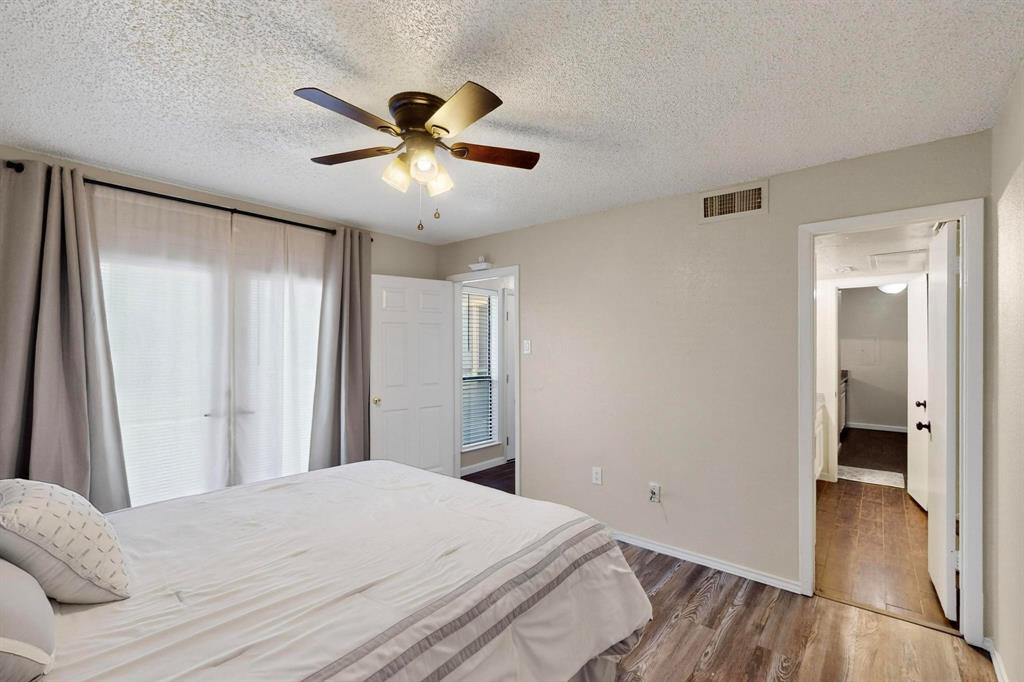 Ceiling fan with integrated lighting, wood-finish flooring, and white interior doors