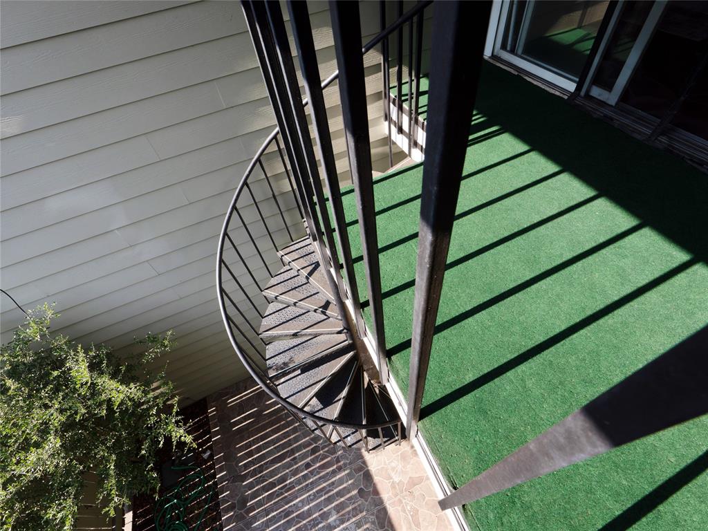 Black metal spiral staircase with perforated steps