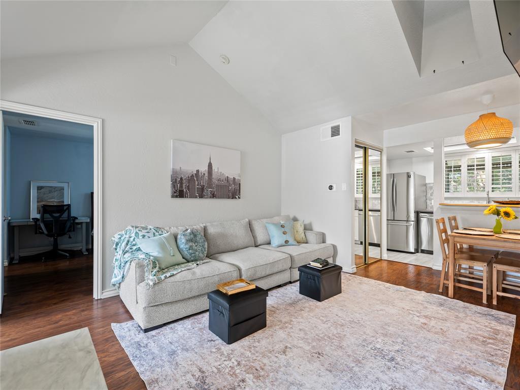 Vaulted ceiling, wood-finish flooring, stainless steel appliances, kitchen pass-through, and plantation shutters Vaulted ceiling, wood-finish flooring, stainless steel appliances, kitchen pass-through, and plantation shutters