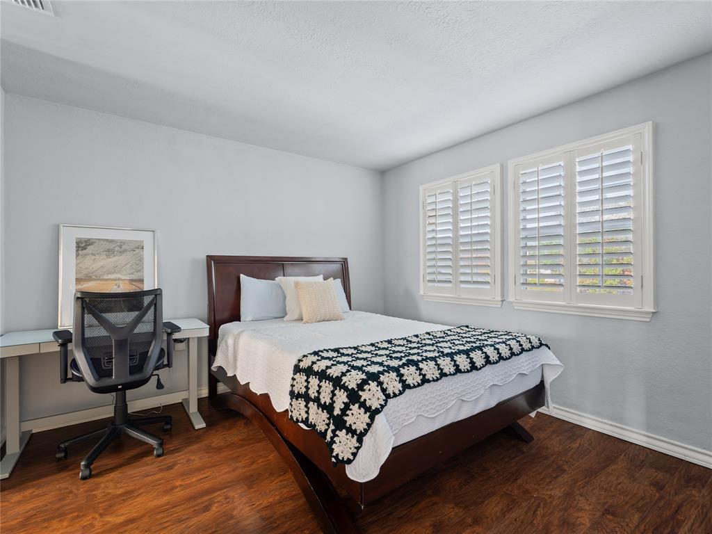 Wood-finish flooring, white walls, and dual windows with plantation shutters Wood-finish flooring, white walls, and dual windows with plantation shutters