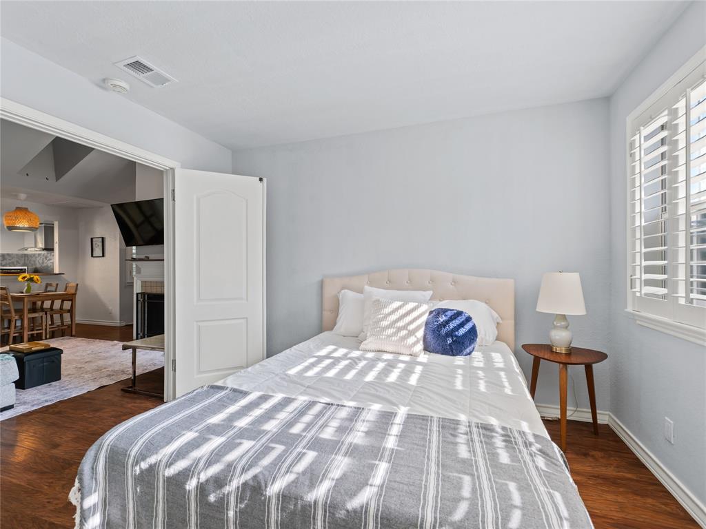 Wood-finish flooring, plantation shutters, and a paneled interior door