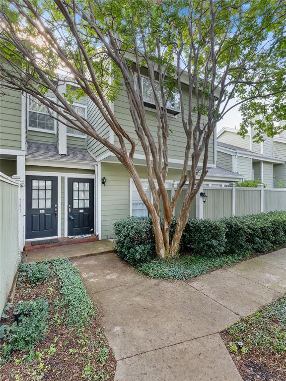 Siding exterior with multiple windows, complemented by mature trees and landscaping