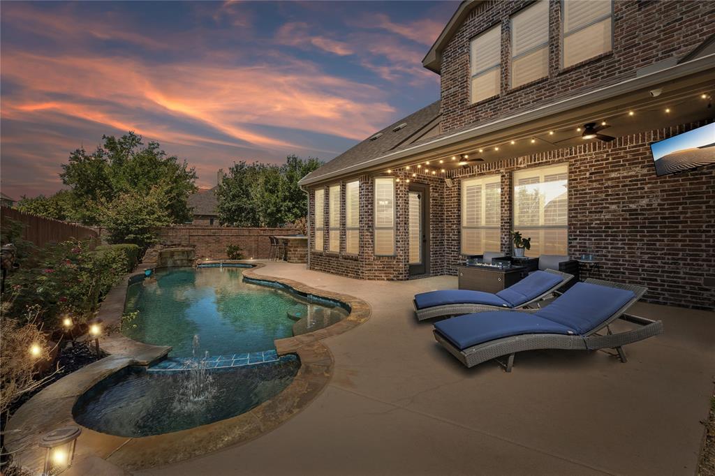 Gorgeaus landscaped backyard features outdoor kitchen and saltwater pool