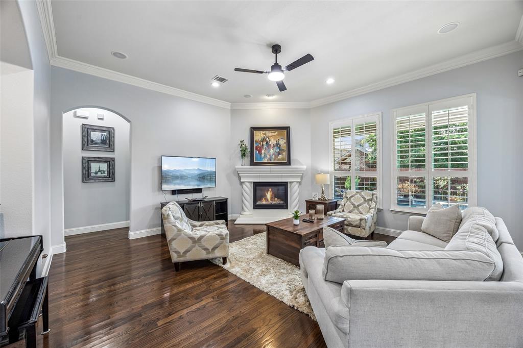 Cozy living room features a stone fireplace and nook for a piano