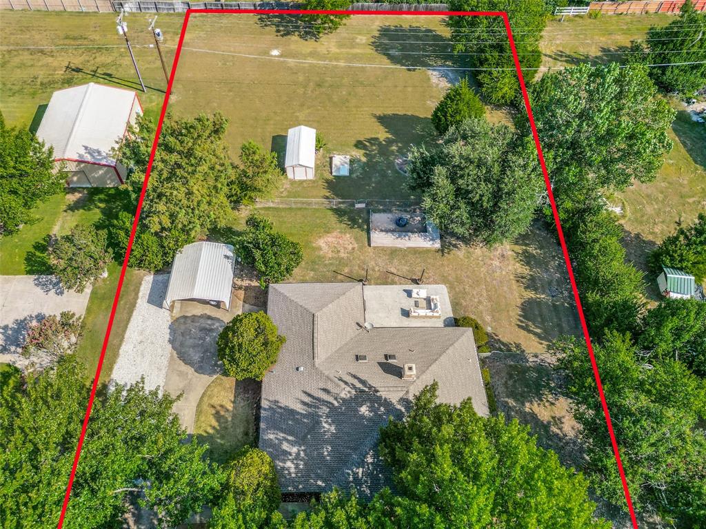 Expansive lot featuring a primary residence, detached carport, two storage sheds, and a large additional structure Expansive lot featuring a primary residence, detached carport, two storage sheds, and a large additional structure