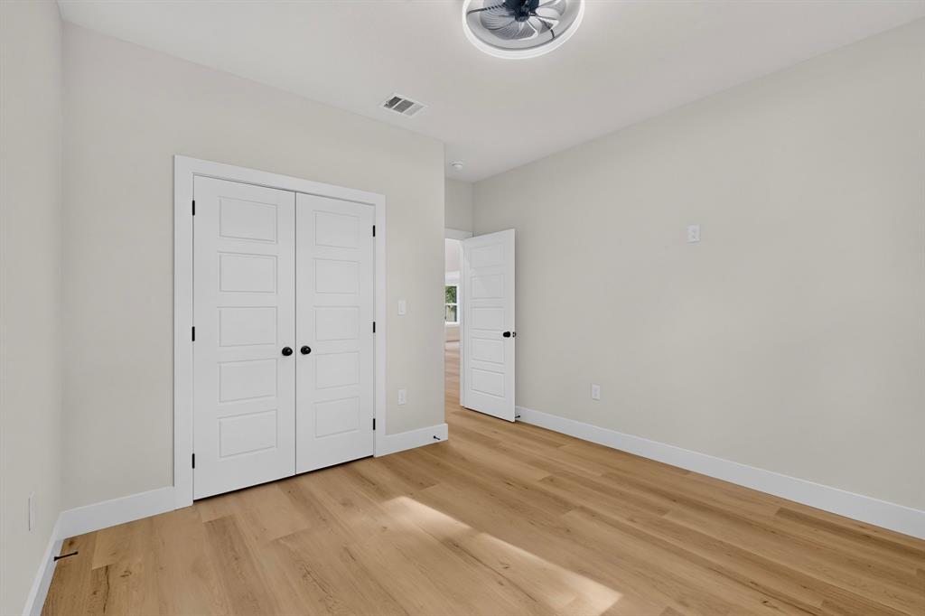 Light wood-finish flooring with white trim