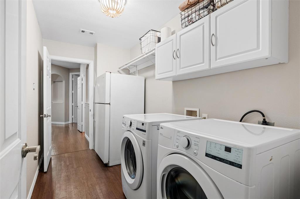 Nice sized laundry room with space for an extra fridge