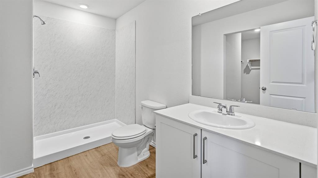 White bathroom vanity with an integrated sink, polished chrome faucet, and quartz countertop