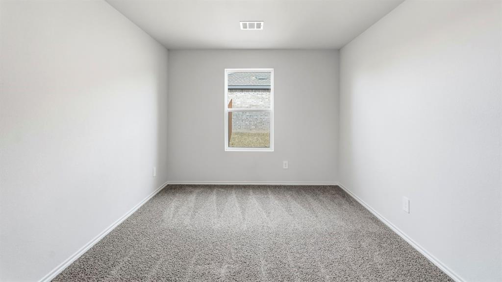 Neutral-toned walls, carpeted flooring, and a single window