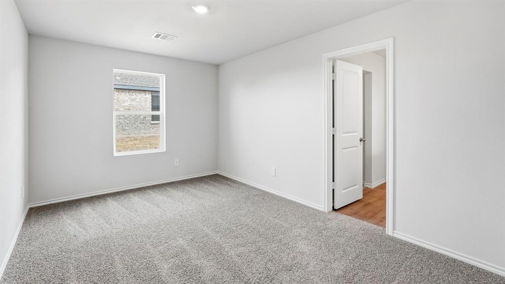 Neutral wall finishes, recessed lighting, and carpeted flooring