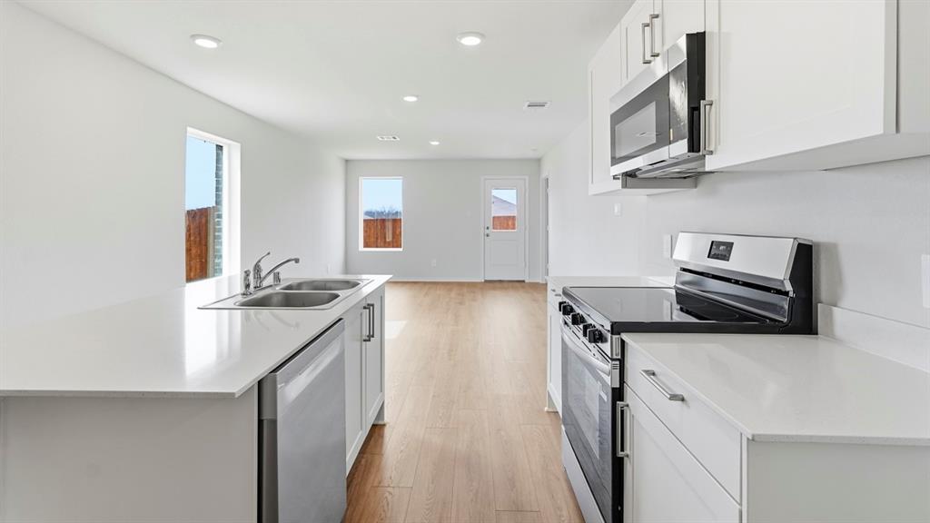 Kitchen featuring white cabinetry, stainless steel appliances, white countertops, and recessed lighting Kitchen featuring white cabinetry, stainless steel appliances, white countertops, and recessed lighting