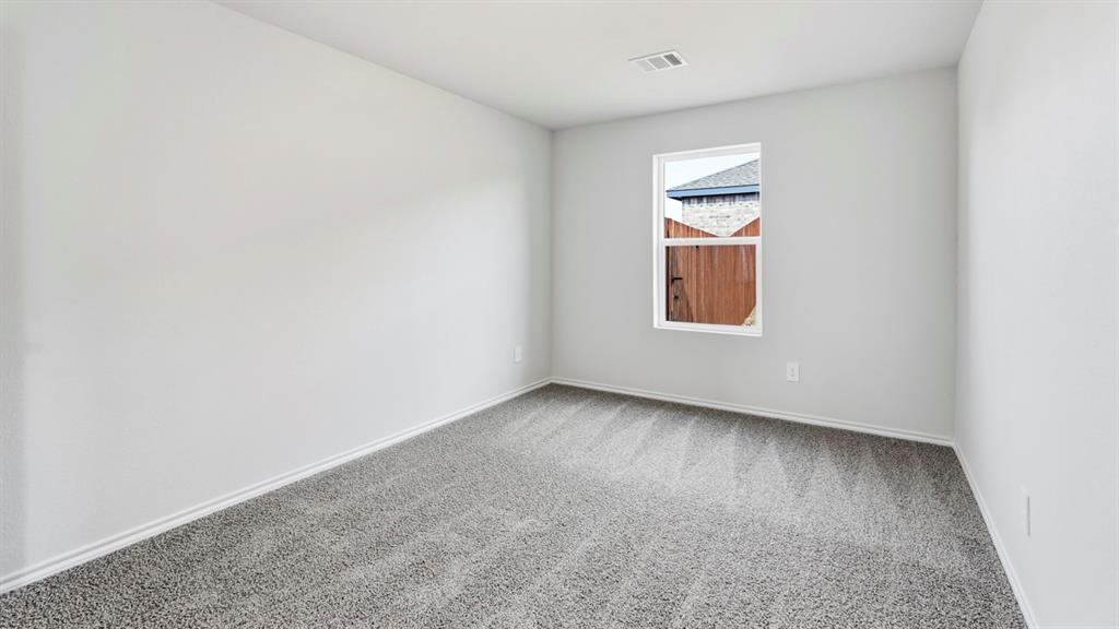 Neutral-toned walls complement the gray carpeted flooring