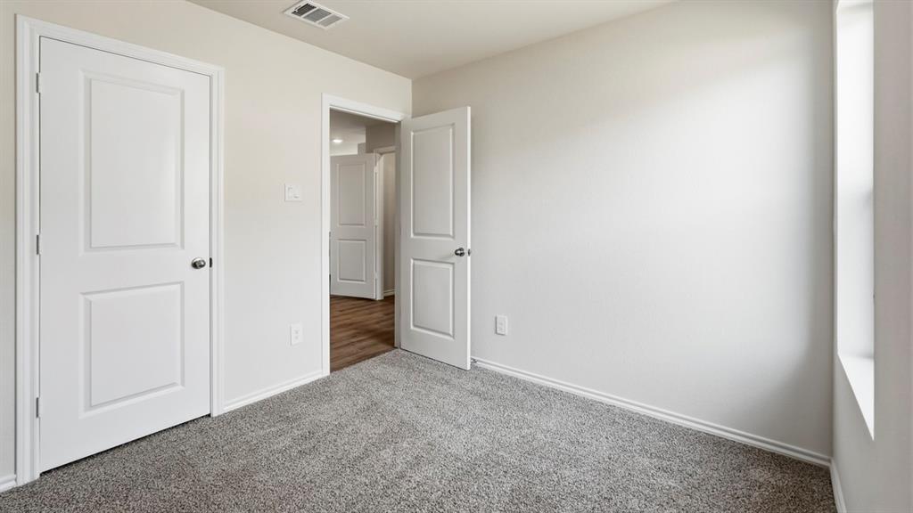 Light grey carpeting with light-colored walls and white trim