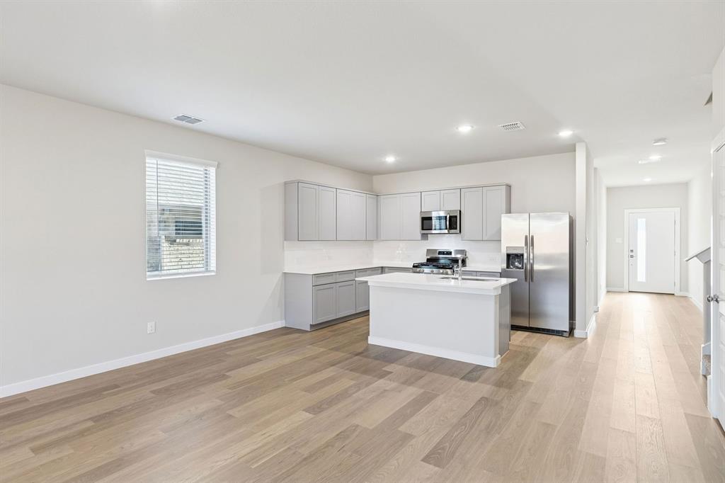 Kitchen and Dining Room in the Haylee home plan by Trophy Signature Homes - REPRESENTATIVE PHOTO