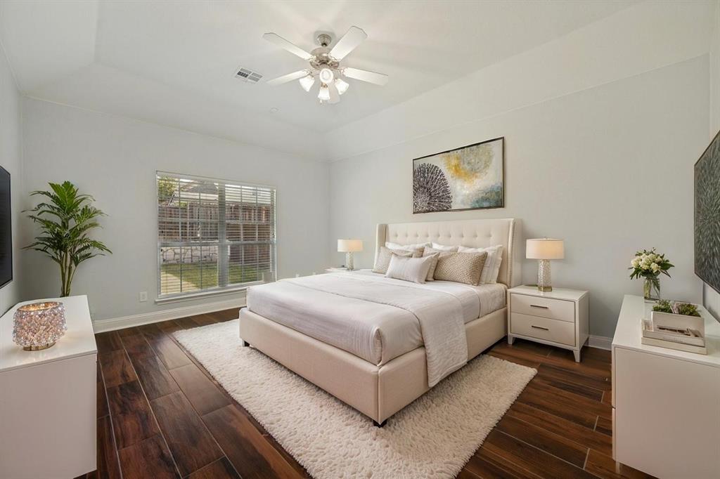 Wood-finish flooring, recessed ceiling, ceiling fan with light fixture, and a window with blinds