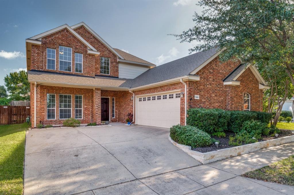 Brick exterior with multiple windows and an attached garage