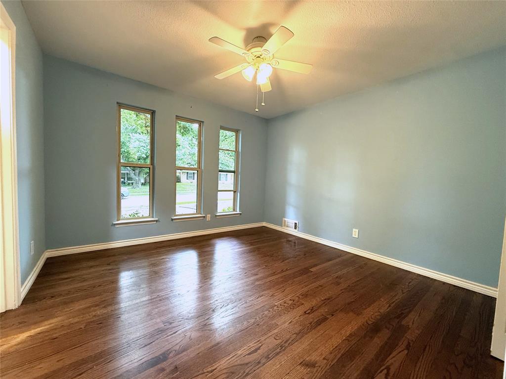 The first bedroom on the hall looks out over the shaded front yard