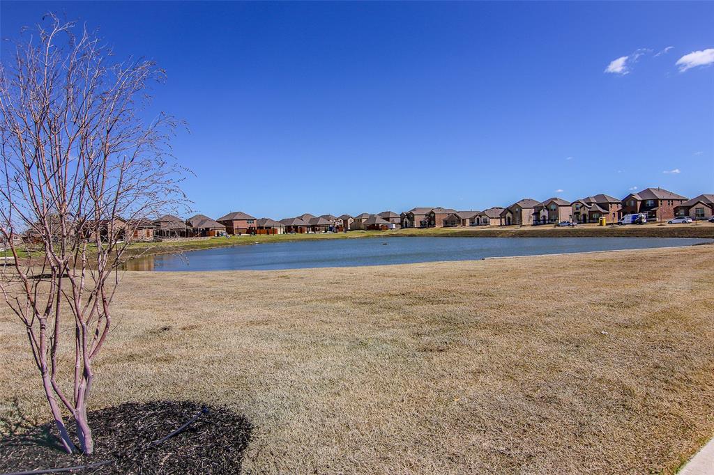 Expansive pond with surrounding residential properties