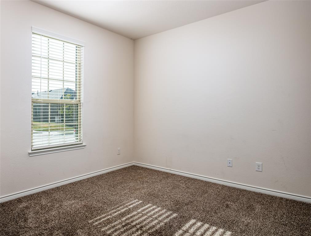 Neutral wall paint and textured carpet flooring