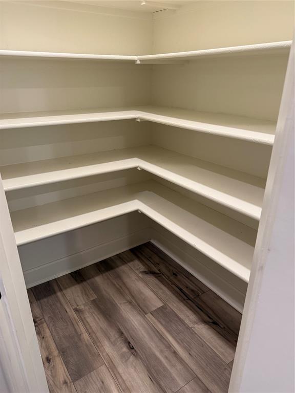 Built-in shelving with multiple levels and wood-finish flooring