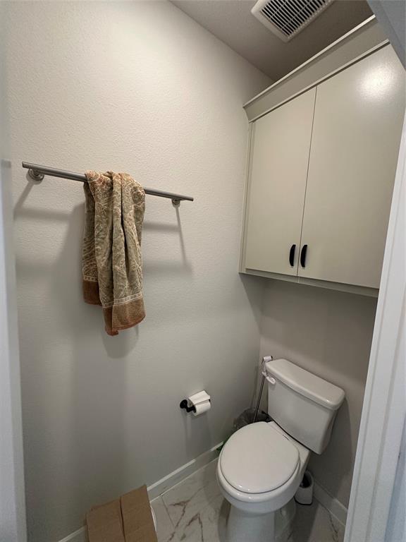Built-in upper cabinetry, ceiling-mounted ventilation, and tile flooring