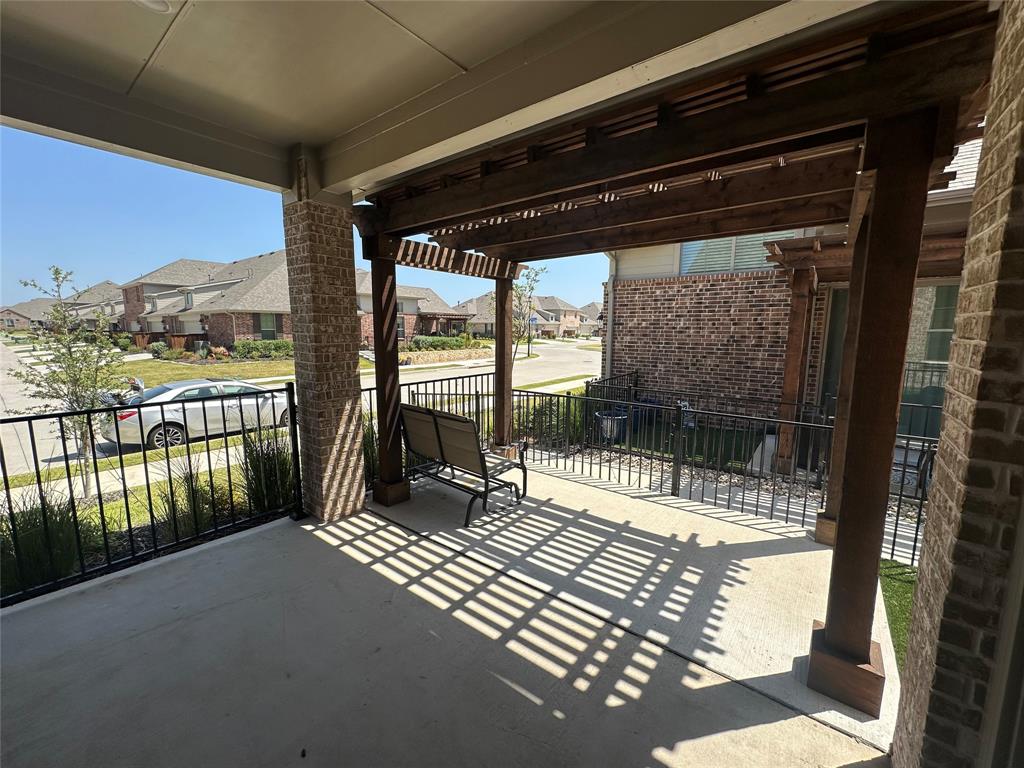 Covered front patio featuring a wood-finish pergola