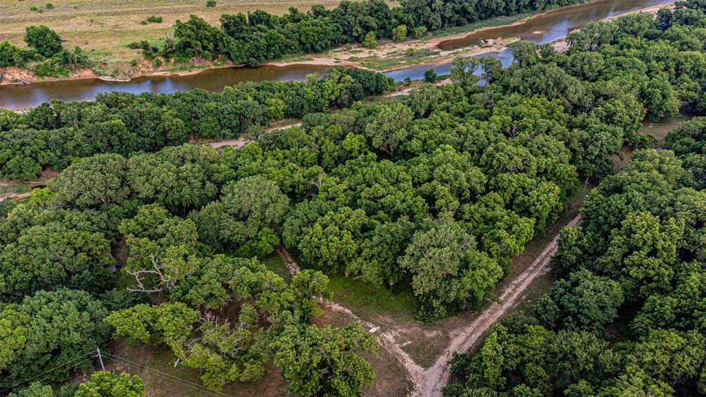 Expansive forested acreage featuring dense tree cover and a winding river